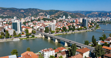 Makedonya'nın başkenti Skopje'nin havadan görünümü, taş köprü ve çevresindeki dağlar